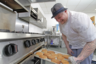 Photo of our cook putting food in the oven.