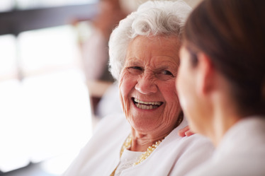 Elderly resident talking to a carer